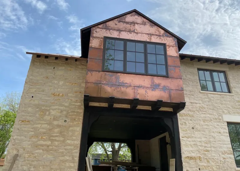 Copper metal panel facade on a stone building for Skylight Installation in Schertz