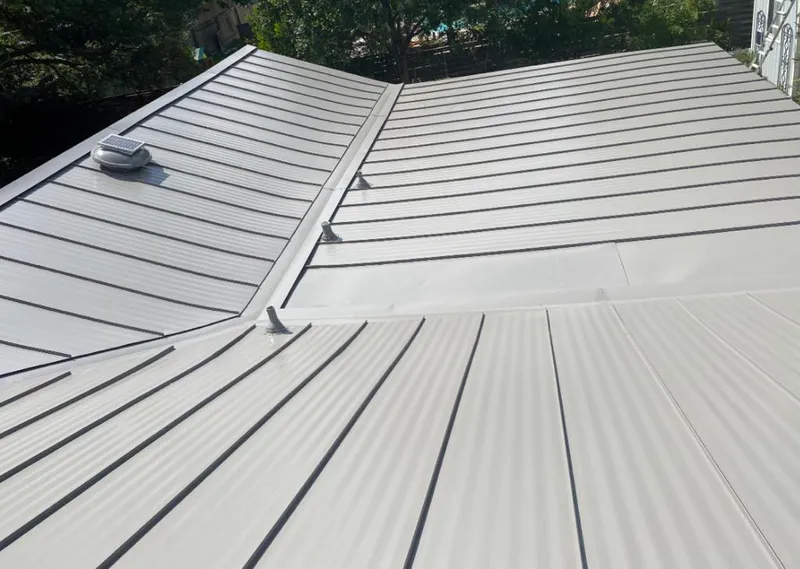 Solar attic fan installed on a metal roof for Roof Ventilation in Schertz